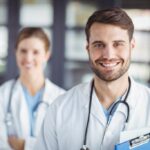 Portrait of happy doctors standing in hospital